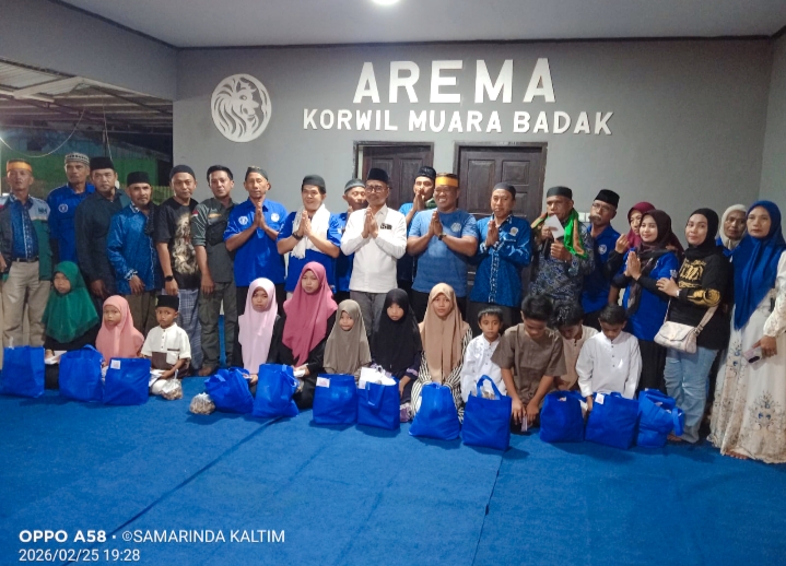 Ketua Paguyuban Arema Muara Badak, Nur Achmad (kanan), didampingi anggota DPRD Kaltim Baharuddin Demmu (kiri) dan Kepala Desa Badak Baru Nasruddin (tengah) berfoto bersama anak-anak yatim penerima santunan