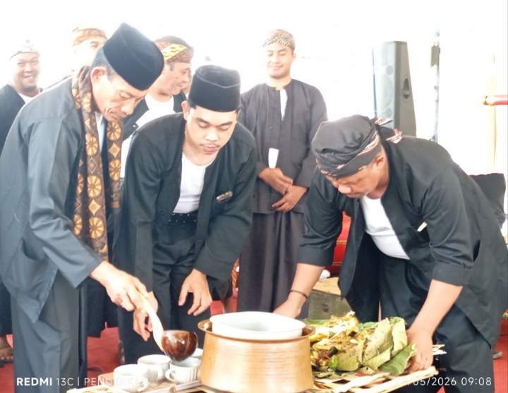 Tampak para perangkat desa ketika menuangkan air ketan hitam untuk di bagikan kepada seluruh yang hadir.