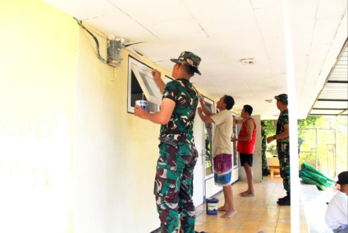 Antusias TNI tampak mengecat dinding tempat ibadah. 